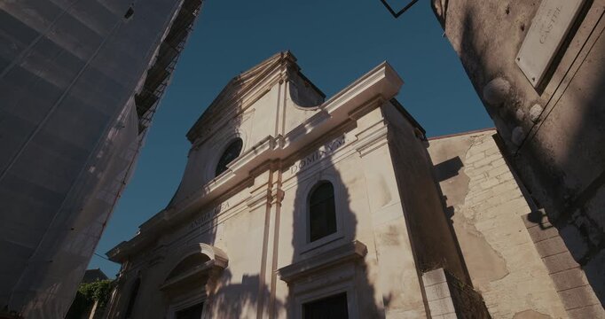 The facade of the Parish Church of the Visitation of the Blessed Virgin Mary shows an arched entrance, columns, and scaffolding on the side.