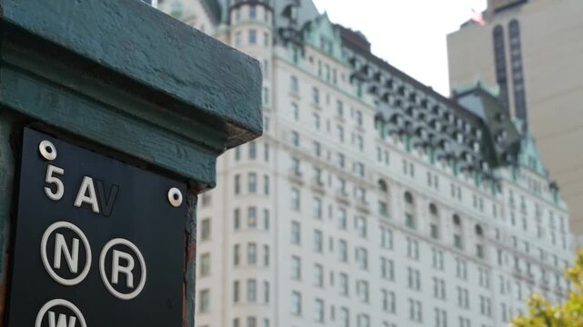 New York City street, subway entrance sign on 5 fifth avenue near Central Park, United States. American underground transportation, Manhattan Midtown transport. Station near Grand Army Plaza and hotel
