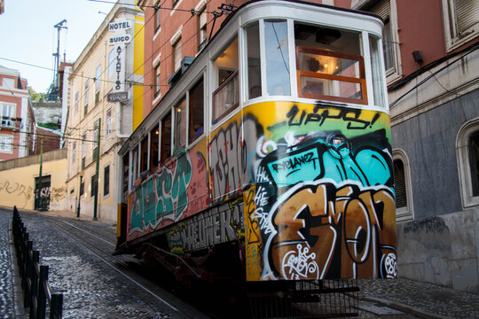 Historical Gloria Funicular (Elevador da Gloria) with its grafitti climbing from Baixa, Praca dos Restauradores to Bairro Alto, Lisbon, Portugal