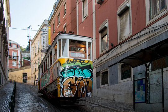 Historical Gloria Funicular (Elevador da Gloria) with its grafitti climbing from Baixa, Praca dos Restauradores to Bairro Alto, Lisbon, Portugal