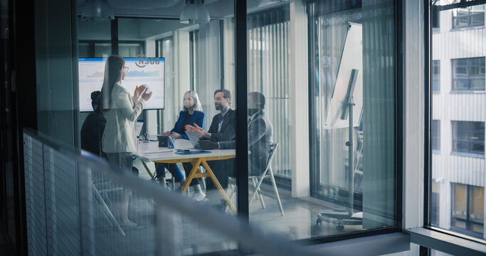 Business Team Meets in a Glass Conference Room to Review Digital Dashboards, Share Updates, and Agree on Clear Priorities, Turning Performance Data Into Simple Action Plans for Growth, Customer Value