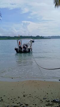 Serene Tropical Beach Scene with Boat and Calm Ocean Waves