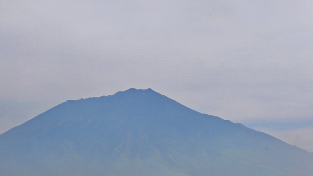 The majestic peak of Mount Arjuno during the blue hour
