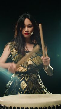 Japanese Female Taiko Drummer Moving Gracefully With Flowing Hair Playing Steady Rhythm Under Stage Light Symbolizing Tradition Energy And Artistic Balance Of Japanese Culture