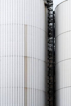 White tank industrial facade with vertical metal lines texture and detail showing a clean structure in a minimal engineering exterior study