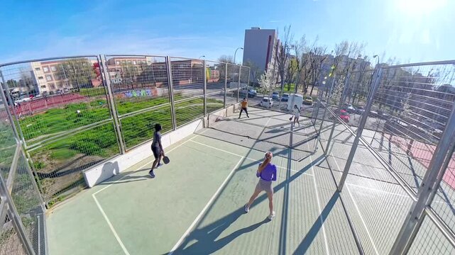 People enjoying pickleball match on sunny day