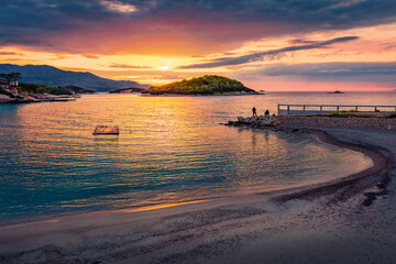Fantastuic summer sunset in Ksamil town. Great evening seascape of Ionian sea. Calm outdoor scene of Butrint National Park, Albania, Europe. Traveling concept background. © Andrew Mayovskyy