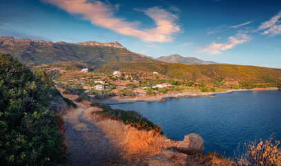 Fototapeta premium Splendid summer view of country road to the beach on Ionian sea. Wonderful evening landscape of small resort in Greece. Attractive outdoor scene of Peloponnese peninsula with beautiful mountains. 