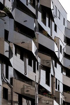 Abstract pattern across windows shapes a modern residential facade where architecture reflects urban Paris France with graphic depth