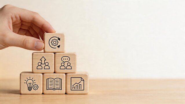Business management strategy building concept hand stacking wooden cubes with icons teamwork learning growth planning process cycle knowledge sharing on light background corporate