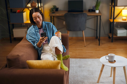 Online shopping at home with smartphone and credit card