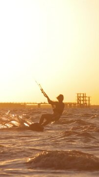 kitesurfing pro big air jump sunset silhouette slow motion technique skill extreme sports professional