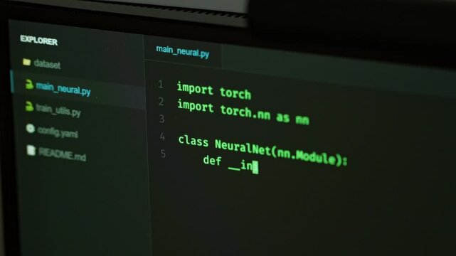 Programming computer code on screen in software development process.