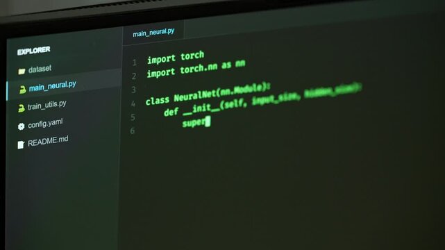 Programming computer code on screen in software development process.