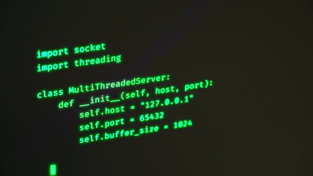 Programming computer code on screen in software development process.