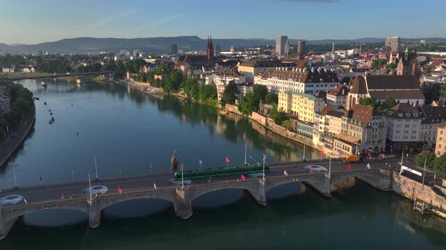 Basel City in Switzerland on Summer Morning. Orange Dawn over the Basler Munster, Church Square and Old town, Aerial.