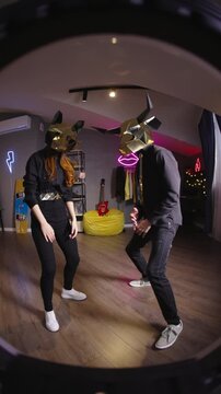 Teen creators wearing gold animal masks filming synchronized dance for short form challenges creator economy ugc fan cam culture virtual performance vibe modern home studio