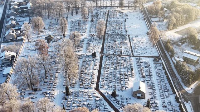 Snowy churchyard with winter trees and burial plots