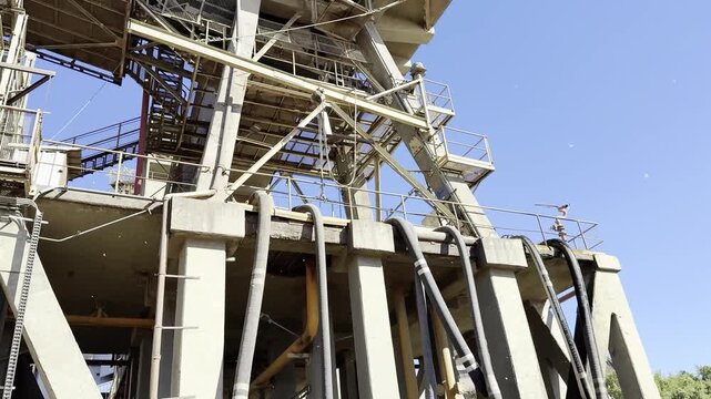 Bulk wheat loaded in cargo hold of large bulk carrier. Grain fills ship hold with hatch coaming and covers visible. Port grain elevator in background. Global agricultural export and trade.