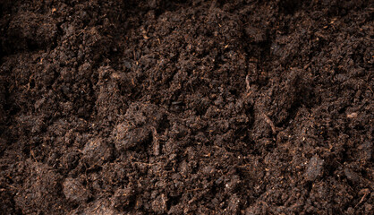 Peat soil textured background. Compost pile, brown garden dirt mound