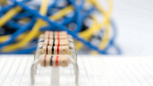 Macro of Ceramic Resistors on Breadboard with Jumper Wires and Soft Lab Bokeh