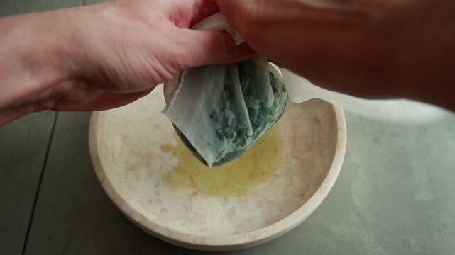 Close-up of draining cooked spinach using a colander to remove excess water
