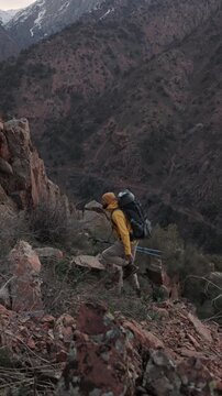 Solo traveler climbing rocky mountain terrain showing resilience healthy lifestyle mindful adventure outdoor freedom wanderlust motivation strength alpine challenge nature escape travel inspiration