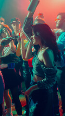 Naklejka premium A vibrant nightclub scene with people dancing and enjoying music under colorful lights. Concept of nightlife party, youth, summer, festivity, celebration