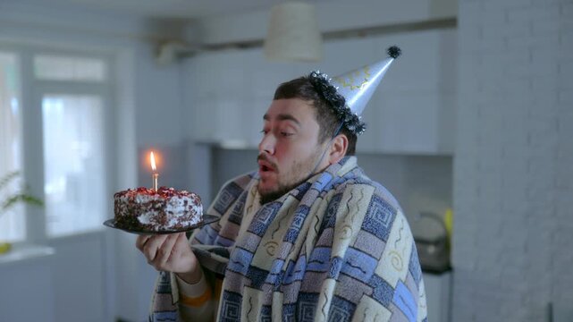 Medium Shot One Surprised Man In Blanket Blowing Birthday Candle