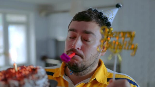 Medium Close Up One Man Holding Birthday Cake Blowing Party Horn