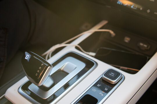 Car gear shift close up. Vehicle interior, transmission control and driving concept.