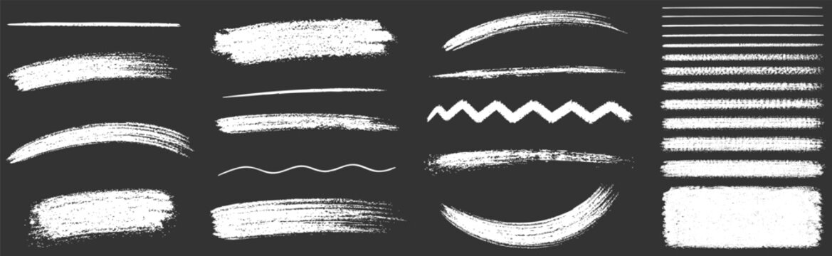 Collection of various white paint brush strokes, dry brush textures, lines, and shapes isolated on a dark background for design elements and overlays.