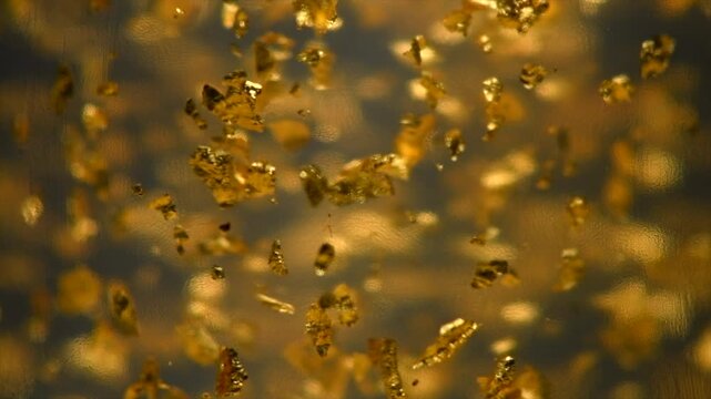 Abstract Gold background. Luxury transparent cream gel with sparkling 24k gold floating particles serum, beauty products, wellness ads. Skin care, face creme, mask, body lotion, moisturizer. Slowmo