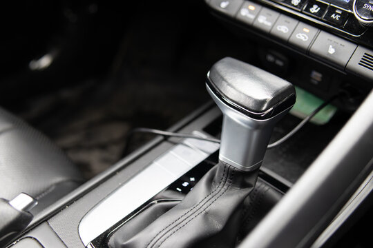 Car gear shift close up. Vehicle interior, transmission control and driving concept.