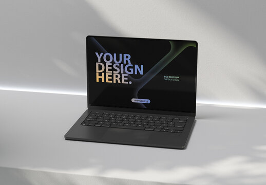 Black Laptop Mockup on white concrete