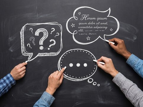 Collaborative ideas and questions emerge on a blackboard with chalk drawings of speech bubbles