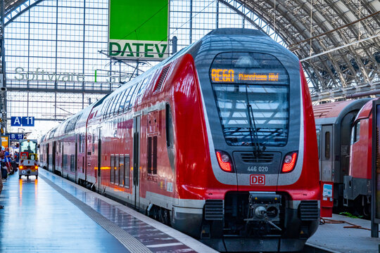 High-speed Regional red DB Regio train at Frankfurt Hauptbahnhof, passengers on platform, modern railway station, major transportation terminal, glass roof, regional rail service, Frankfurt, Germany