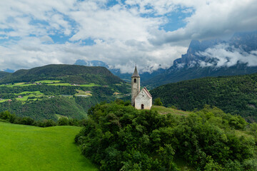 Fototapeta premium Aerial view of St. Andreas Renon Church, Dolomites Bolzano, South Tyrol, Italy