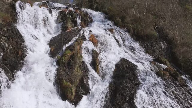 Stunning View Of Fervenza das Bra&ntilde;as Waterfall In Toques, A Coru&ntilde;a, Spain. Aerial Slow Motion Shot