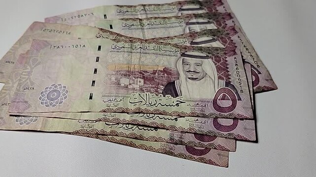 Financial concept featuring a five riyal banknote for topics related to cash flow, economy, and monetary exchange.