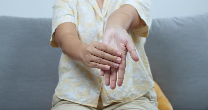 Explore effective hand stretching techniques for relaxation and flexibility in a calm indoor setting.