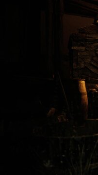 A serene cabin scene captures the soft glow from a crackling fire illuminating rough stone walls. The atmosphere is inviting, perfect for warm conversations and quiet reflection.