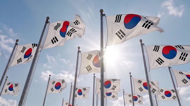 Multiple South Korean Flags Waving Against a Bright Sunny Sky