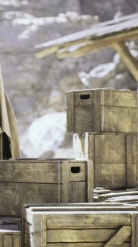 In a sunlit outdoor location, weathered wooden crates are carefully stacked. The scene captures a sense of organization amidst nature, inviting curiosity and exploration.