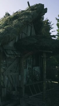 Weathered and worn, the wooden cabin stands peacefully among tall trees, its thatched roof blending with the surroundings. A sense of history fills the air as time seems to pause.