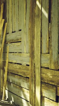 Sunlight dances upon the uneven surface of aged wooden planks. The natural colors blend harmoniously, showcasing a rustic charm that speaks of history and craftsmanship.