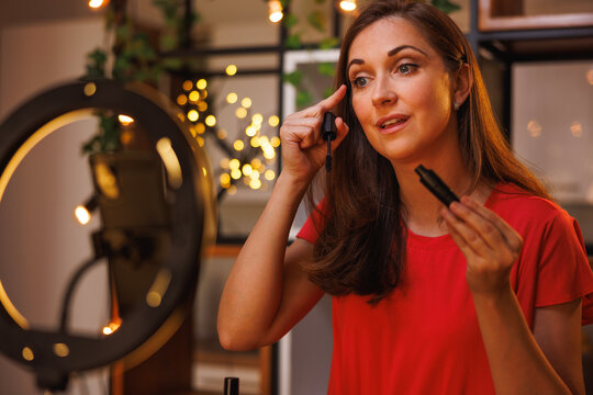 Beauty and makeup influencer filming content for social media about mascara application