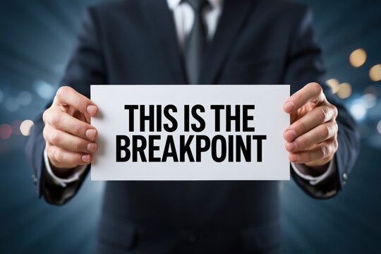 Man in a Suit Holding a Sign This Is The Breakpoint