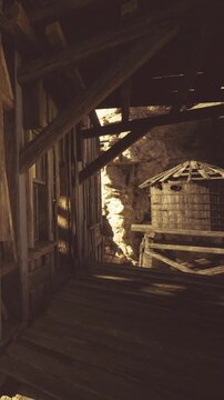 Golden rays shine through gaps in the old wooden beams, illuminating the rustic interior of a deserted building. Shadows dance on the walls, creating a mystical atmosphere.