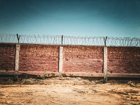 Barbed wire fence under blue sky 